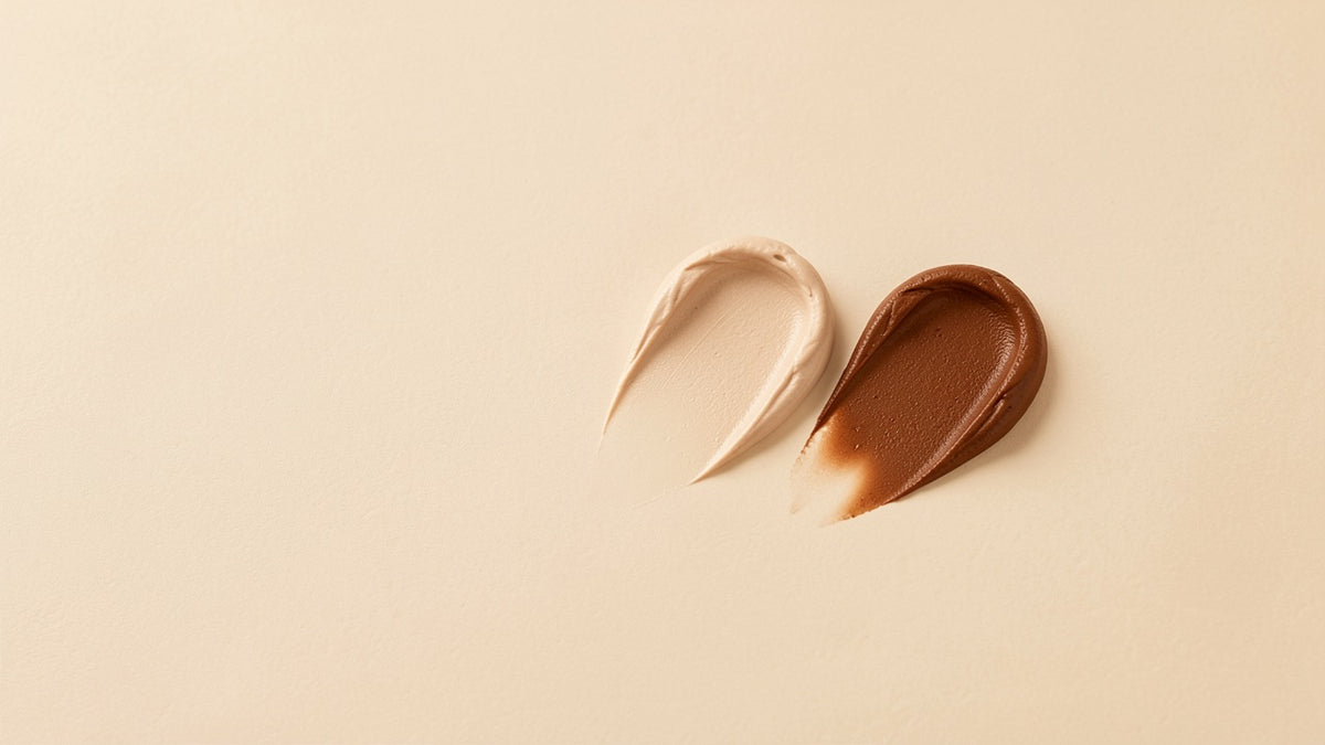 Two swatches of tinted mineral sunscreen, one light and one deep