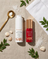 Two skincare products, 'Protectif' and 'Rejuvenat', from the brand 'sajic' on a textured surface with seashells and green leaves.
